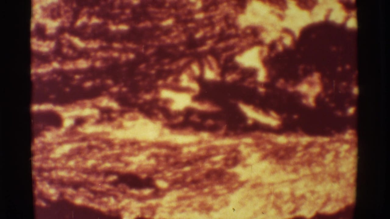 Close view of molten lava patterns and dark rock edges.