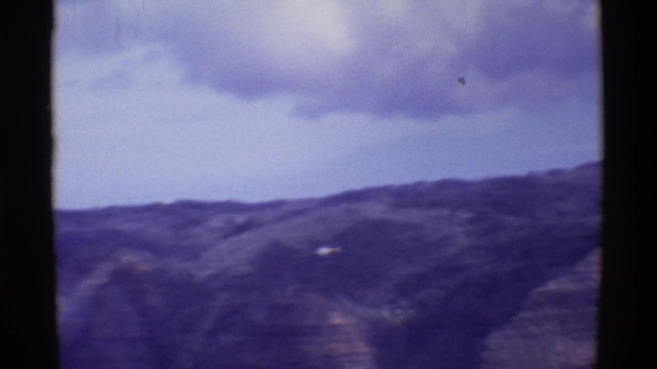 1971 8mm Mauna Ulu overlook footage showing distant hills and a small helicopter-like shape over the canyon.