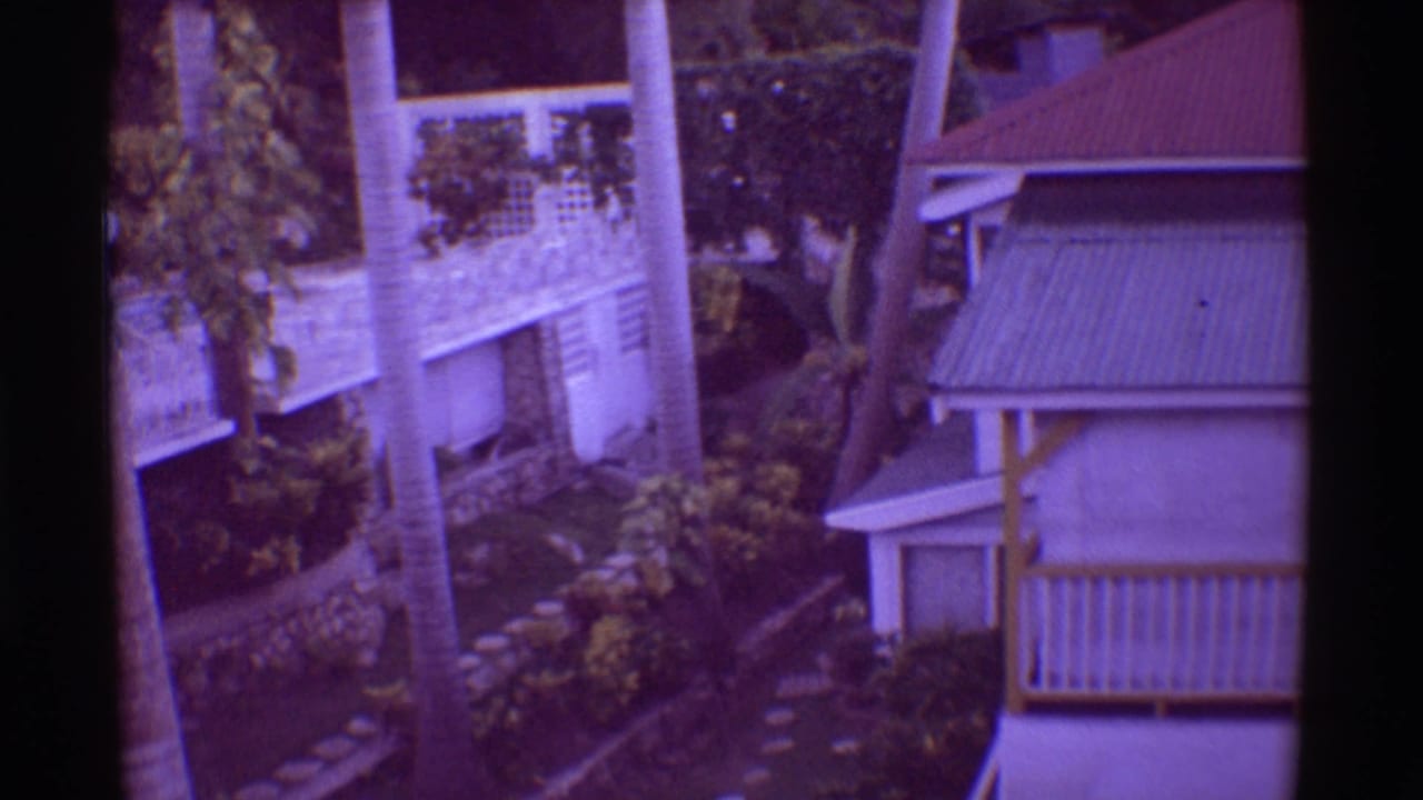 1971 Hawaii resort buildings with lattice details, palms, paths, and landscaped tropical grounds.