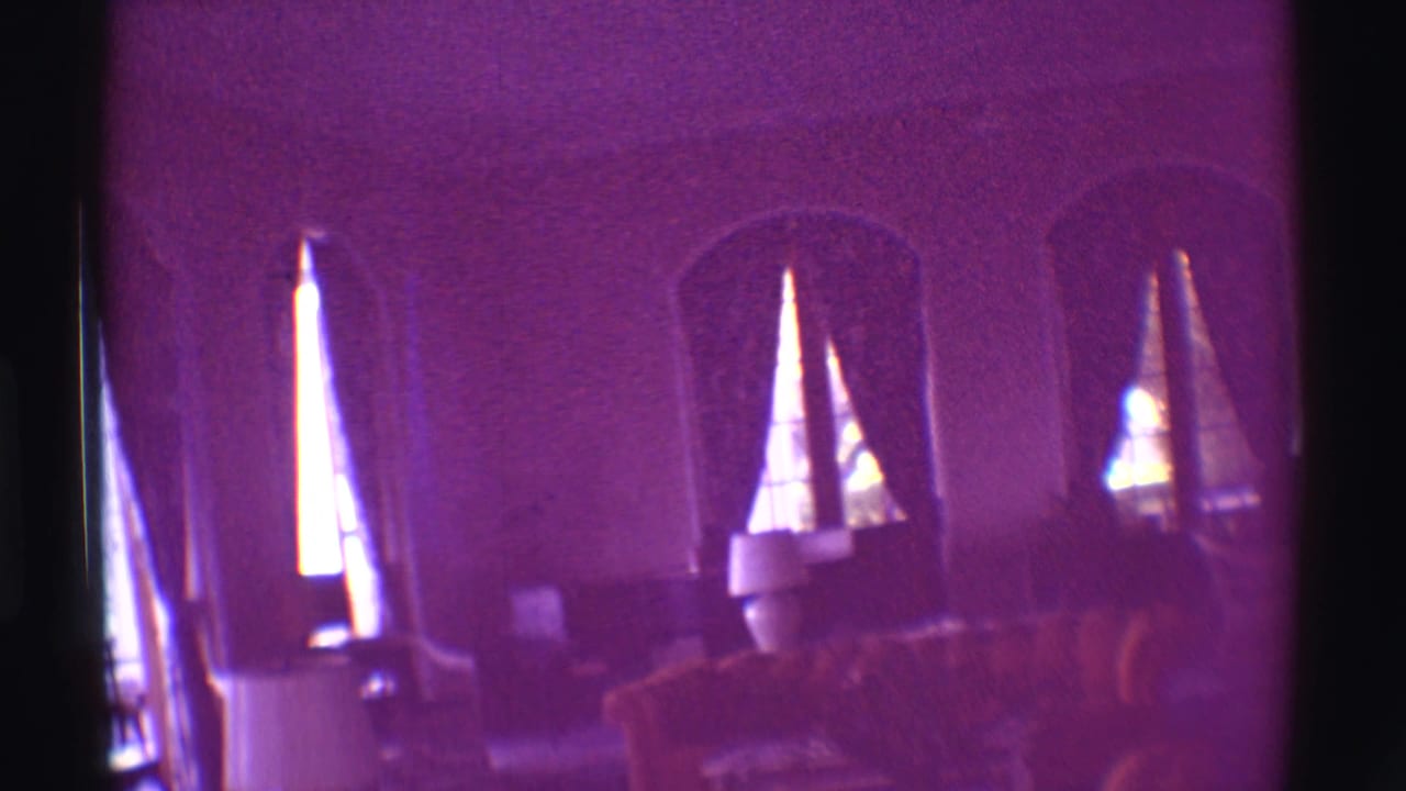 Purple-shifted 1971 Hawaii interior frame with arched windows, drawn curtains, seating and soft 8mm exposure.