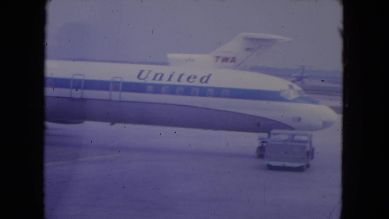United aircraft fuselage on an airport tarmac with a TWA tail behind it.