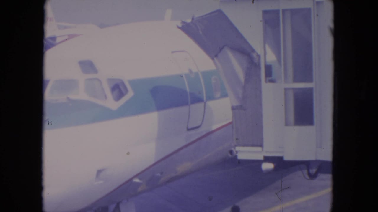 1972 O'Hare frame with the aircraft nose, cockpit windows, and jet bridge connected near the forward door.