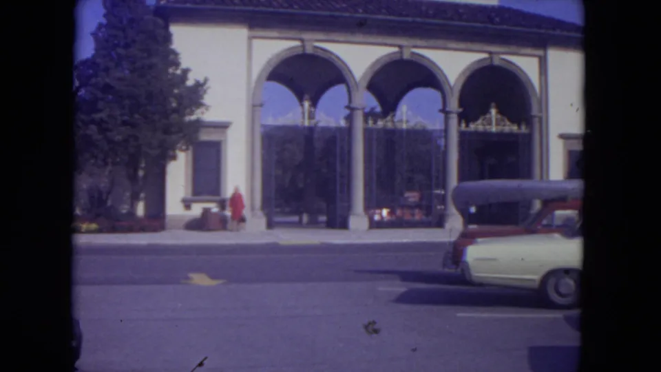 Lincoln Park, Illinois exterior showing three arches, decorative gates, a woman in red near the sidewalk, and a car at the curb.