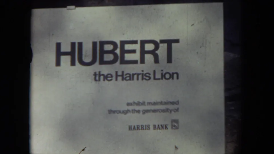 The 1972 home-movie frame holds on the Hubert the Harris Lion sign with Harris Bank branding visible below.