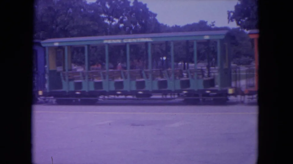 1972 Colby, Wisconsin frame showing a green Penn Central open-air passenger car on the miniature park train ride.