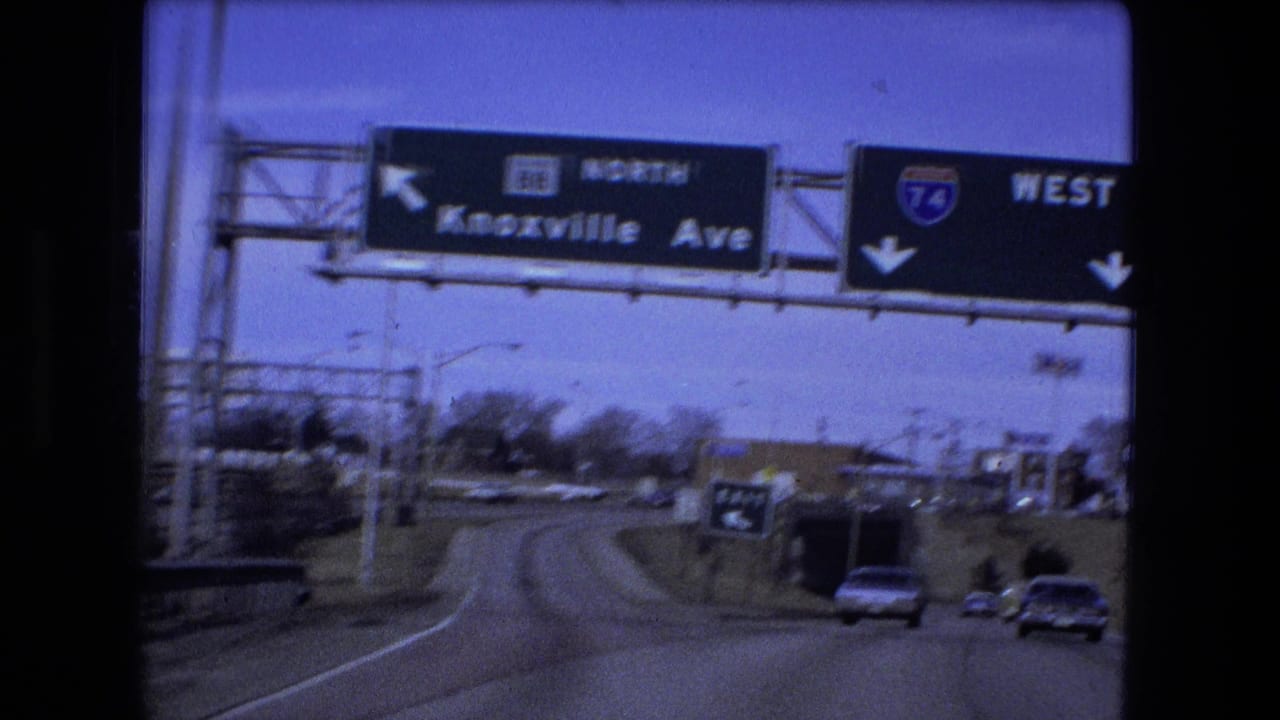 Closer roadway view under signs for Knoxville Avenue and I-74 West.