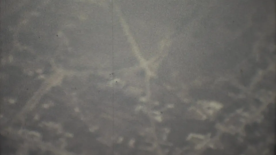 1973 8mm Mexico City travel footage showing a soft, hazy view below from an aircraft-window perspective.