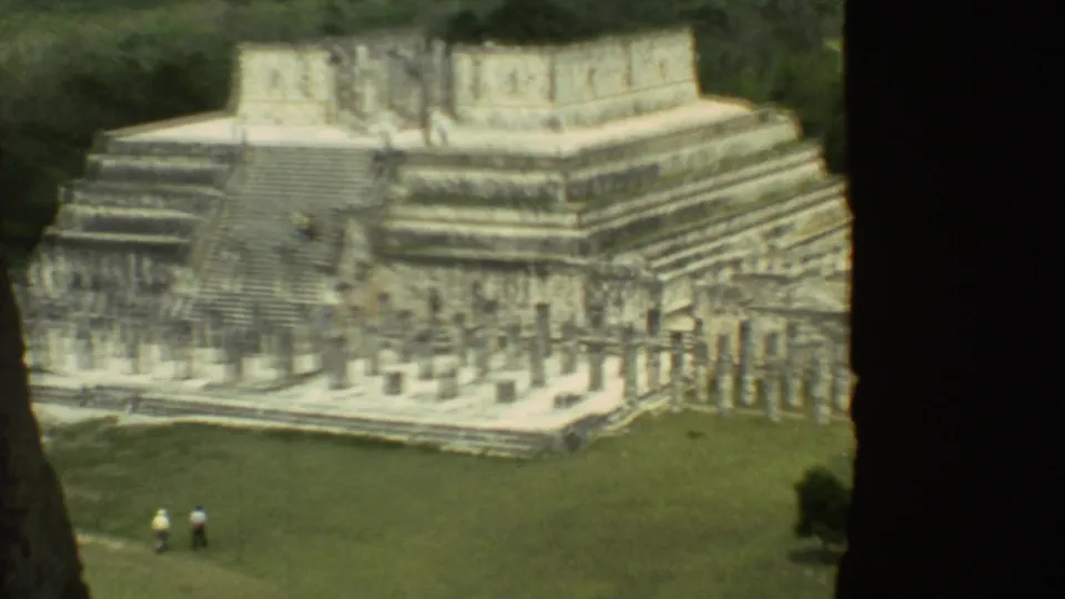 The final frame shows the temple's stairways and stonework, with distant visitors crossing the grass below.