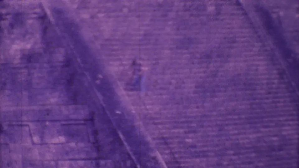 Soft 8mm frame showing the pyramid stairway and surrounding stonework with a distant climber on the steps.