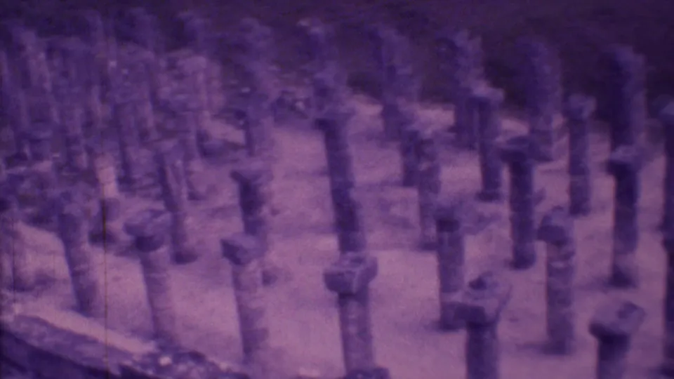 1973 Mexico City 8mm frame showing rows of short weathered stone pillars in an open historic-looking site.