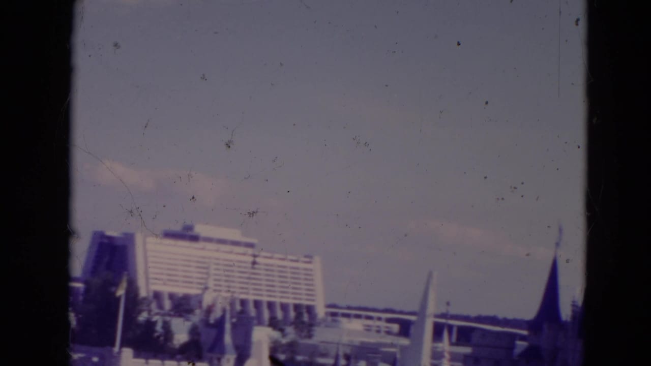 Contemporary Resort with elevated structure and a dark pointed roof at right.