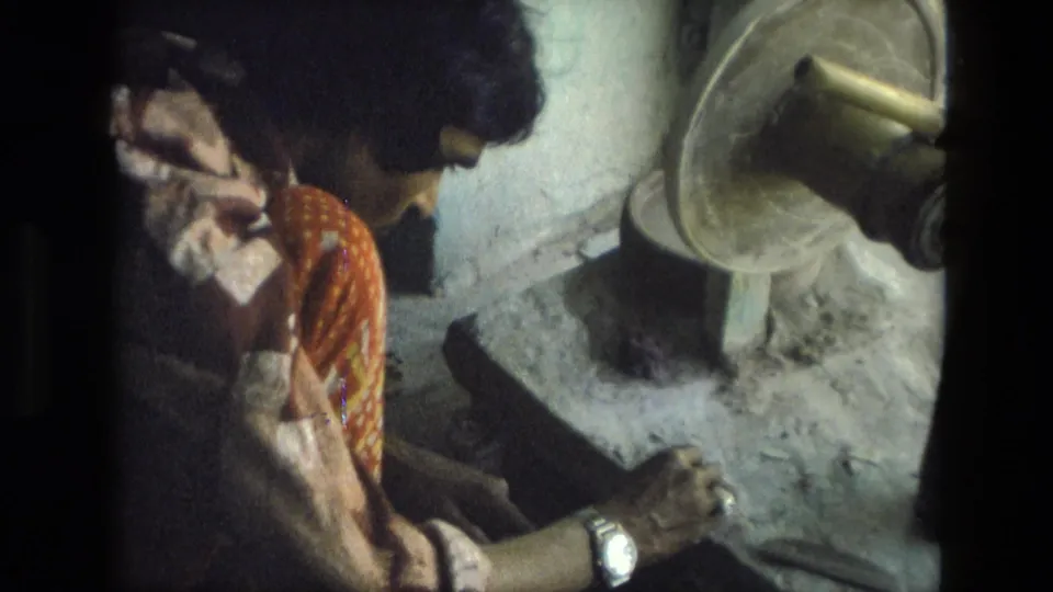 A 1974 India workshop view shows the artisan leaning toward her hand work with a mounted grinding wheel at the side.