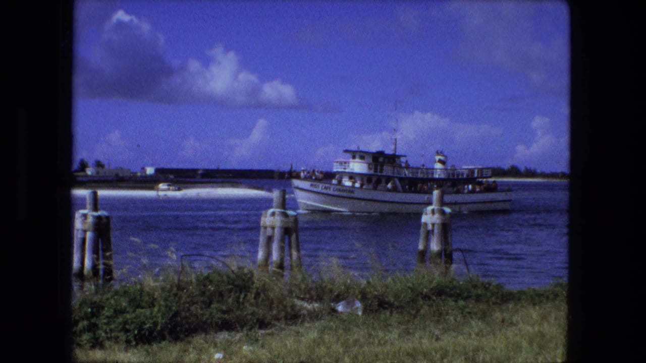1974 Fort Wayne home-movie frame of the Miss Cape Canaveral passenger boat passing pilings on a calm waterway.