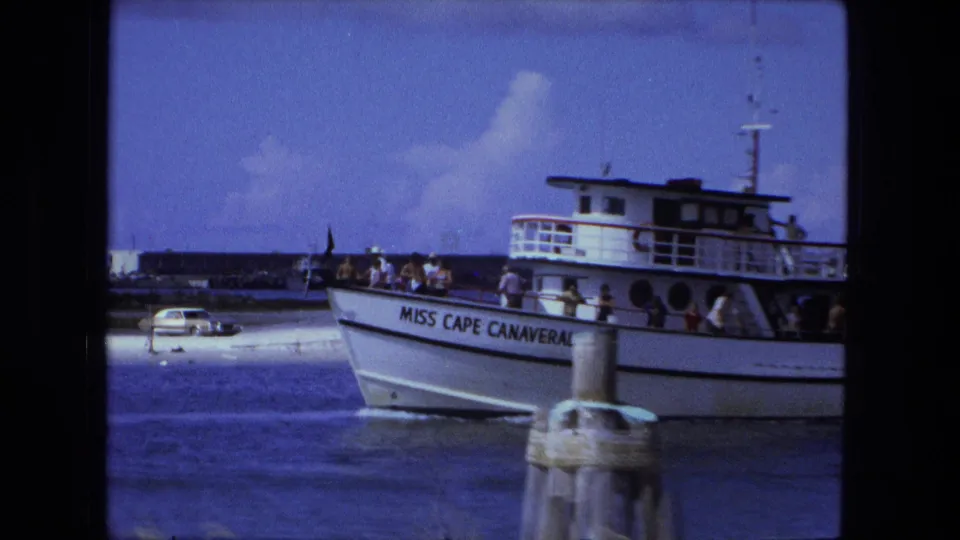 Close 1974 8mm view of the Miss Cape Canaveral name on the hull, with passengers and cabin details visible.