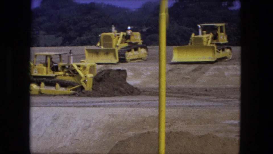 1974 Fort Wayne excavation view with yellow tracked bulldozers spread across an open dirt work area.