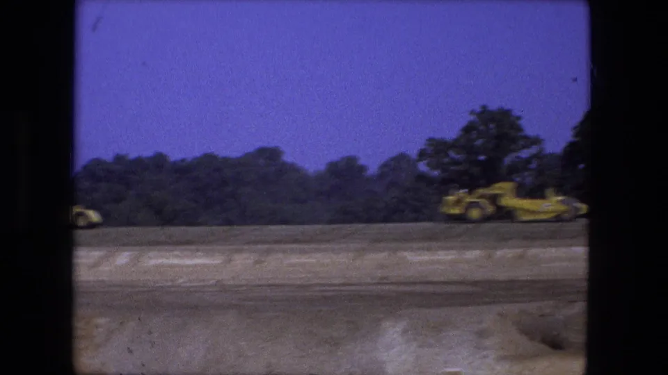 At the end of the clip, the yellow water truck is near the right edge of the Fort Wayne construction scene with open graded ground in view.