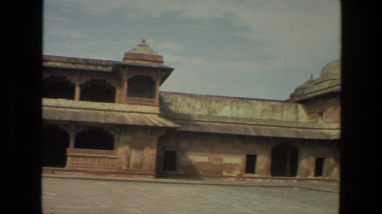 Palace courtyard wall with arched openings and domed rooftop pavilions.