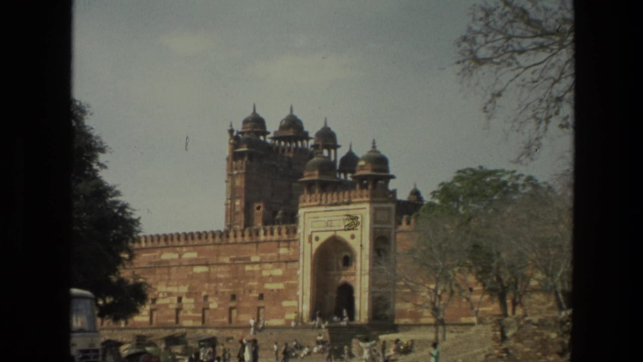 Historic gateway and walls with distant visitors in front and dark 8mm frame borders.