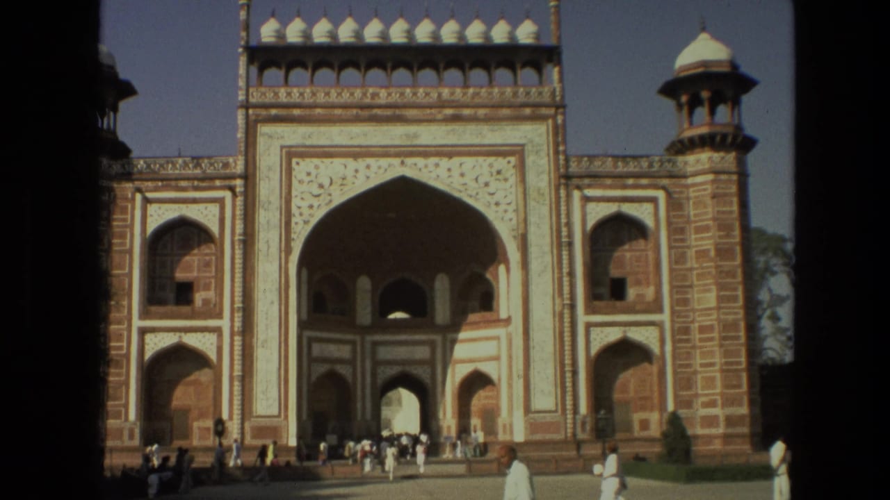 Ornate gateway facade with visitors gathered near the central arch.