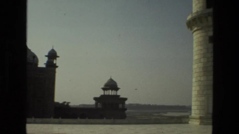 The 1974 India frame shows a monument courtyard with a domed pavilion, distant horizon, pale column, and dark doorway or window framing.