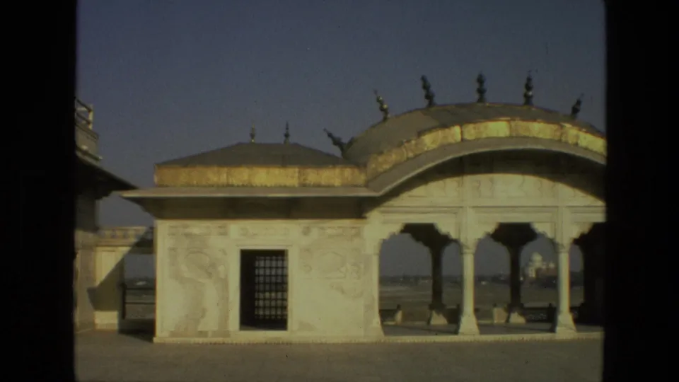 1974 India 8mm frame showing a Mughal-style marble pavilion with a domed roof, arches, carved trim, and open courtyard space.
