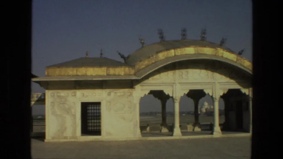 1974 India frame with carved pavilion walls, open arches, domed rooflines, and the Taj Mahal visible in the distance.