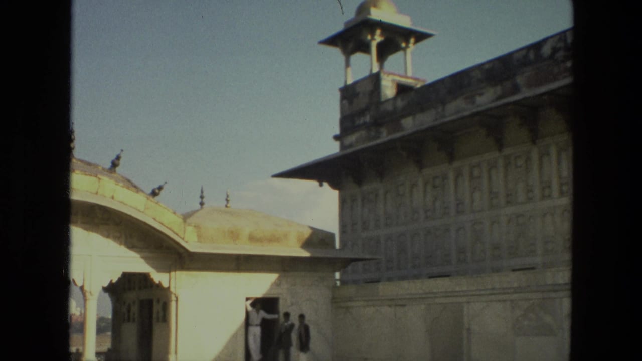 Palace courtyard seen through dark foreground framing with arched stone architecture.