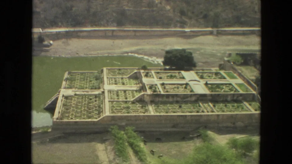 1974 India 8mm frame looking down over formal gardens, paths, water, trees, and surrounding grounds from a high architectural viewpoint.