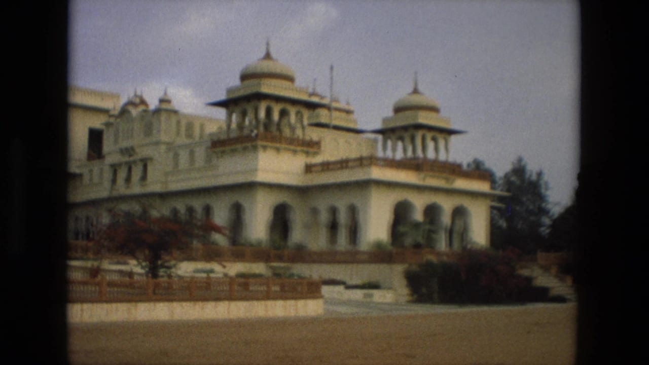 1974 India 8mm view of a pale palace-like exterior with domed roof pavilions, arches, terrace railings, and garden plantings.