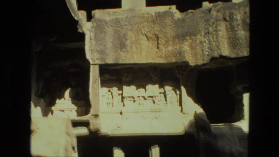 Later 1974 India frame of the rock-cut facade, emphasizing carved architectural detail, natural shadow, and the cave wall around it.