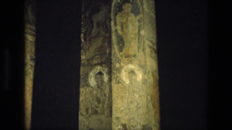 1974 India 8mm frame with a narrow view of a textured vertical architectural detail beside dark contact-sheet borders.