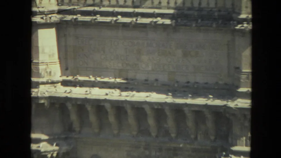 1974 India 8mm frame showing a historic stone monument surface with faint inscription lettering and decorative architectural details.