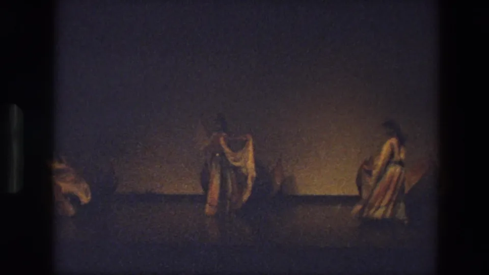 Near the end of the 1974 India clip, two dancers remain clearly visible with veils extended while another performer is partly outside the frame.
