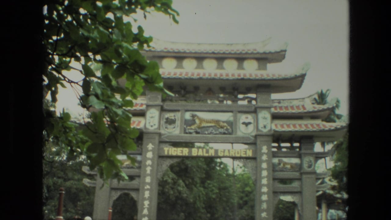 Ornate Tiger Balm Garden entrance gate with trees and a tiger relief above the lettering.