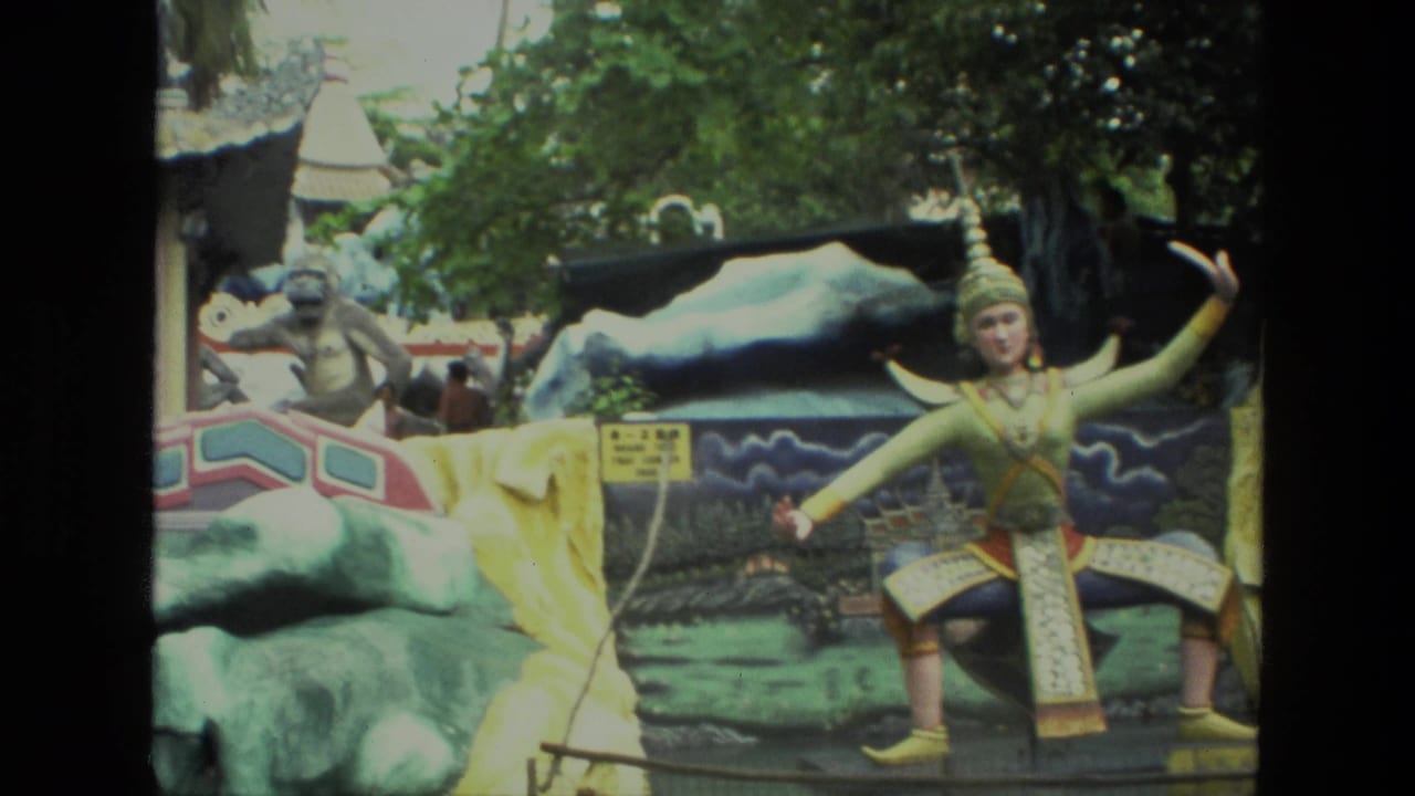 Colorful statues and painted rock forms beside a decorative garden structure.