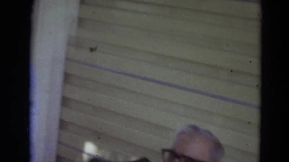 Older man with glasses is partly visible at the edge of a 1974 Lincoln, Nebraska porch scene.