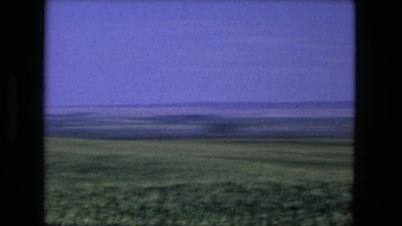 Open field near Fort Wayne, Indiana, seen in 1976 8mm home-movie footage with a low horizon and tinted sky.