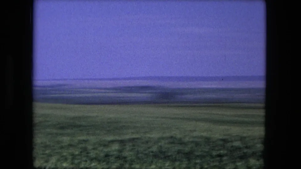 Open field near Fort Wayne, Indiana, seen in 1976 8mm home-movie footage with a low horizon and tinted sky.