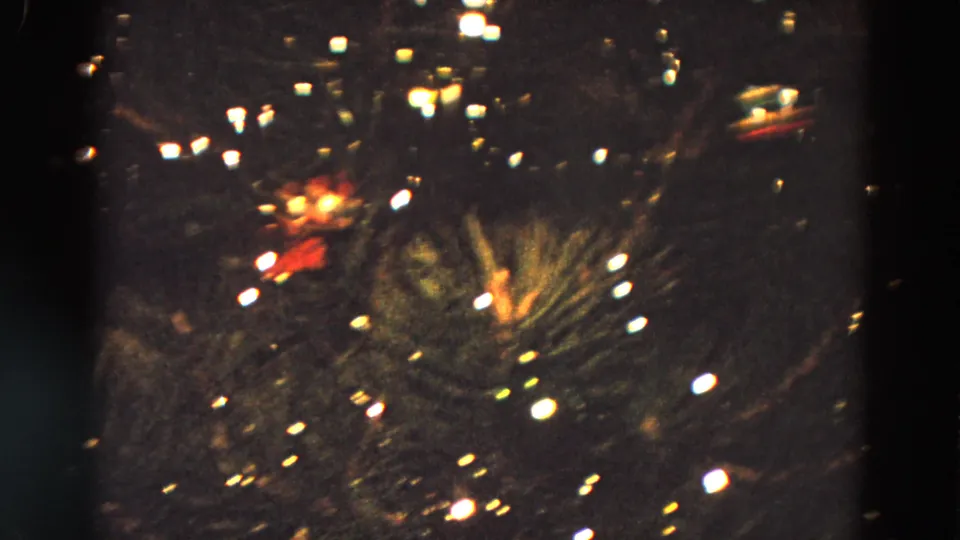 1968 Diller, Nebraska home-movie frame showing a decorated Christmas tree with bright lights in a dark setting.
