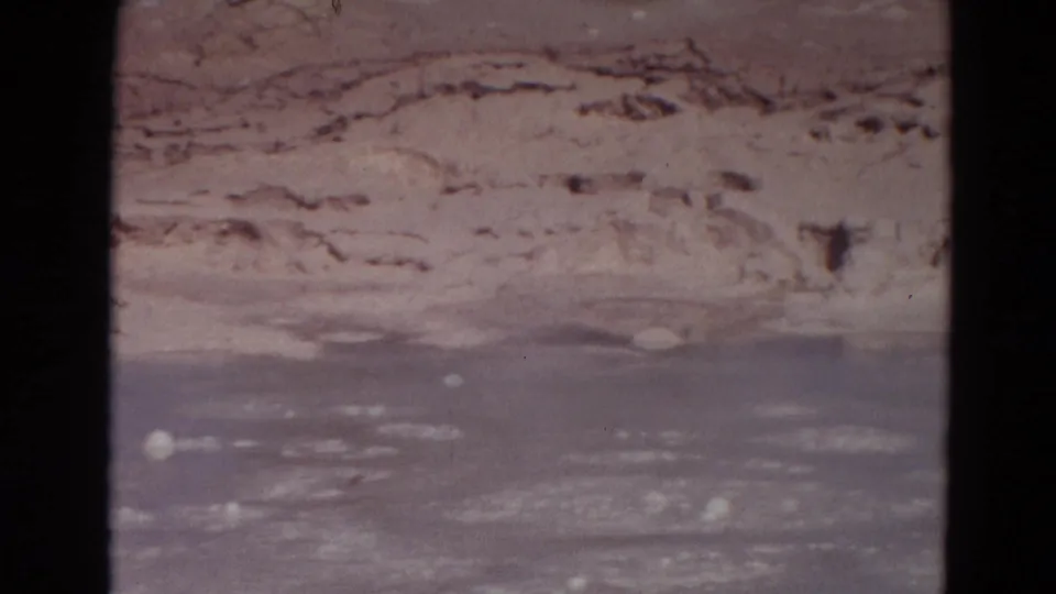 Close 1967 Yellowstone 8mm view of terraced mineral formations and wet thermal surface near Old Faithful.