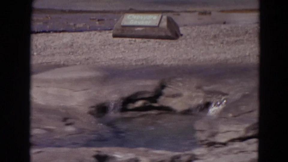 Visitor-shot 1967 Yellowstone footage shows Clepsydra Geyser bubbling across wet rock, with the park sign partly readable above.