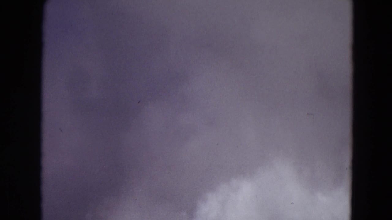 Large pale steam cloud fills the lower frame against a purplish sky.