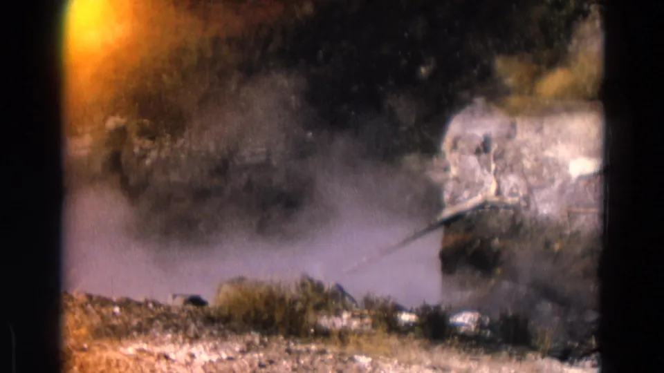 1967 Yellowstone 8mm frame with steam, rocks, low brush, and a warm orange exposure flare along the film edge.