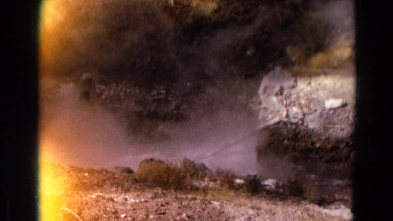 Geyser spray crossing a rocky landscape with strong orange edge flare.