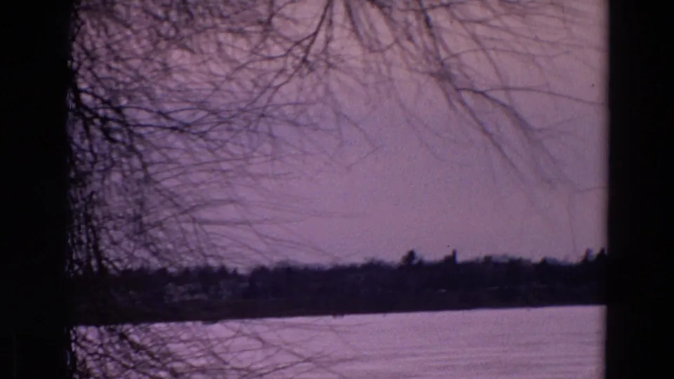 A second 1967 Yellowstone Park winter view shows a frozen lake or snow-covered surface under bare branches with a dark distant shoreline.