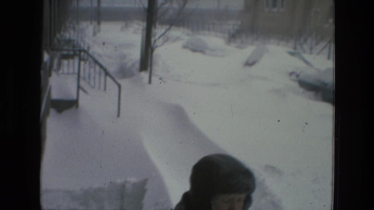 Drexel Hill 1978 home-movie frame showing deep snow near steps or a walkway, with a bundled person partly entering the lower frame.