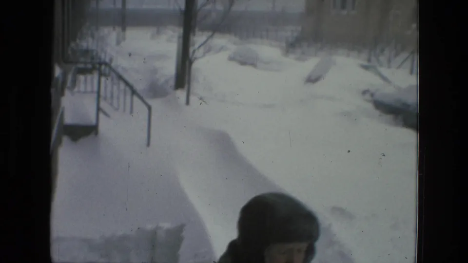 Drexel Hill 1978 home-movie frame showing deep snow near steps or a walkway, with a bundled person partly entering the lower frame.