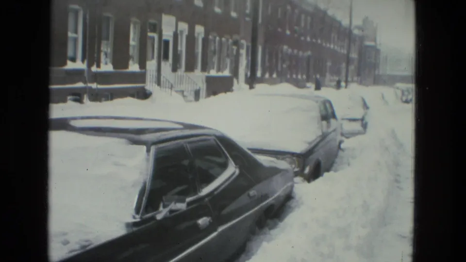 Drexel Hill, Pennsylvania 1978 frame showing parked cars buried in snow along a brick residential block.