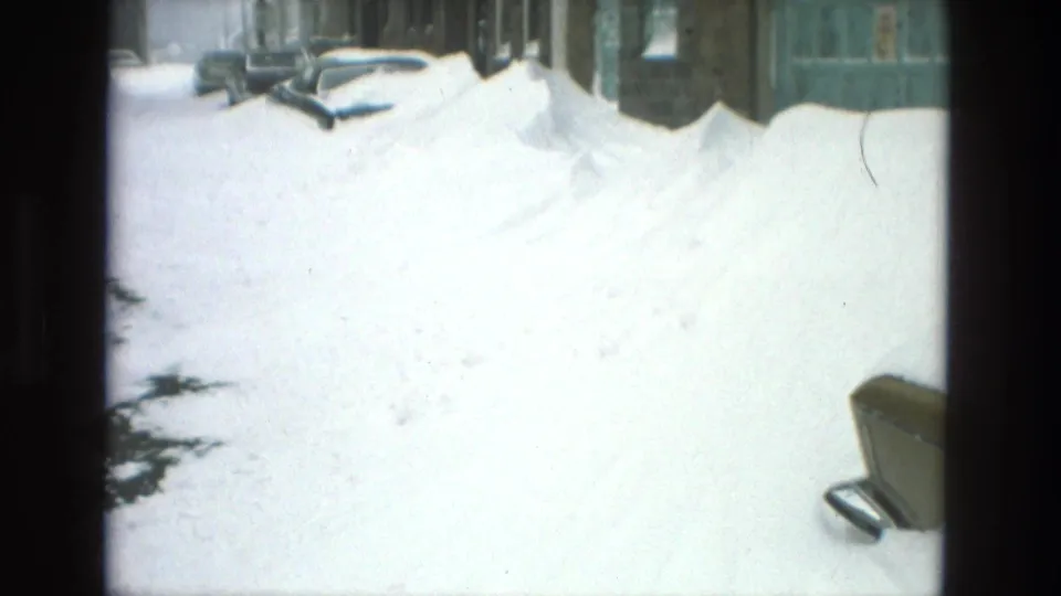 Snow-covered Drexel Hill street in 1978 with high drifts against parked cars and residential buildings.