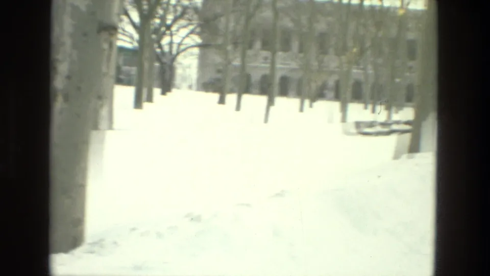 A bright, overexposed 8mm view of snow-covered grounds with bare trees in Drexel Hill, Pennsylvania.